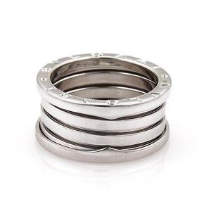 May include: A silver ring with four bands, each with a different design. The top band is the widest and has a row of small circles. The second band is slightly narrower and has a smooth surface. The third band is even narrower and has a row of small circles. The bottom band is the narrowest and has a smooth surface.