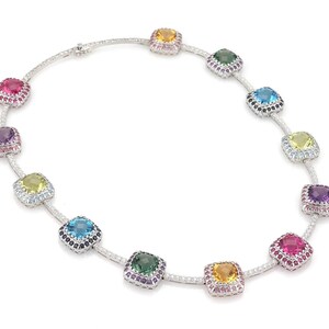 May include: A dazzling necklace featuring a series of square-cut gemstones in various colors, including pink, purple, yellow, green, and blue. The gemstones are set in a silver or white gold chain, with smaller accent stones around each larger gem.