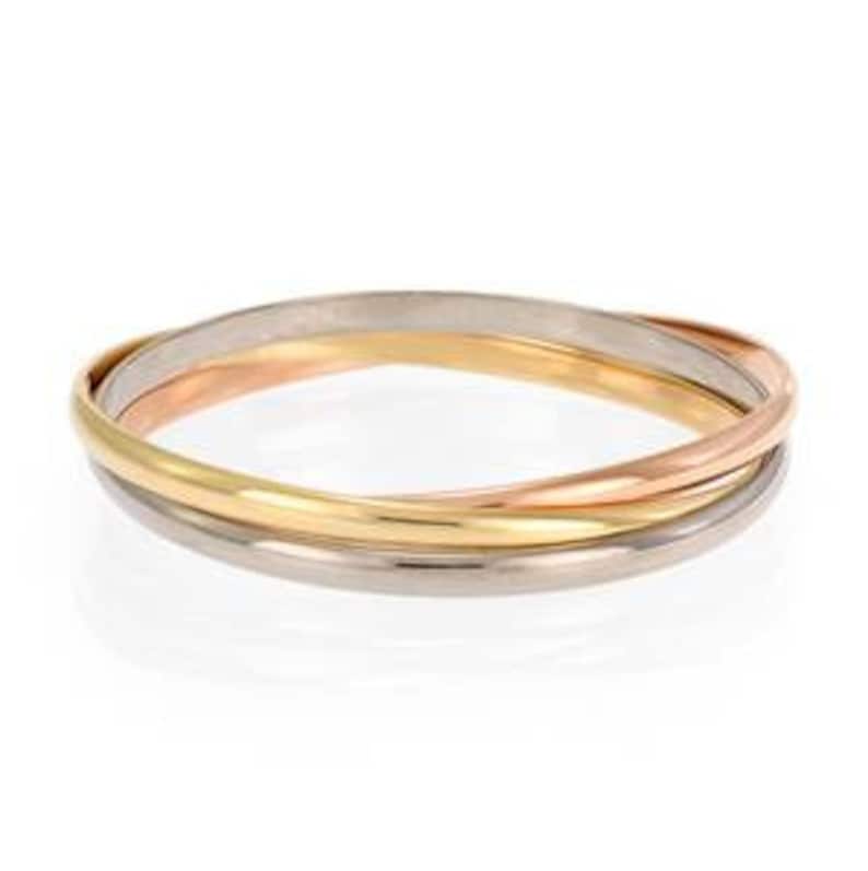 May include: A triple band ring with three bands of different colors: yellow gold, rose gold, and white gold. The bands are intertwined and form a continuous circle.
