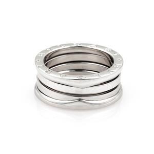 May include: A set of four silver stacking rings with a textured design. The rings are stacked on top of each other and are made of a shiny metal.