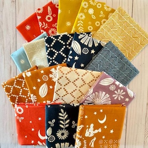 May include: A collection of folded fabric squares in various colors and patterns. Designs include floral, geometric, and celestial motifs. Colors range from orange and yellow to blue and navy, with white accents. Ideal for quilting or crafting projects.