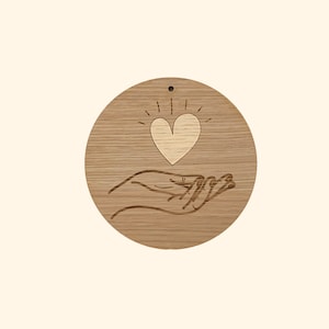 Wooden wall decoration heart on hand
