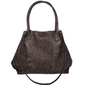 May include: A brown leather tote bag with a crocodile embossed pattern. The bag has two top handles and a long shoulder strap.