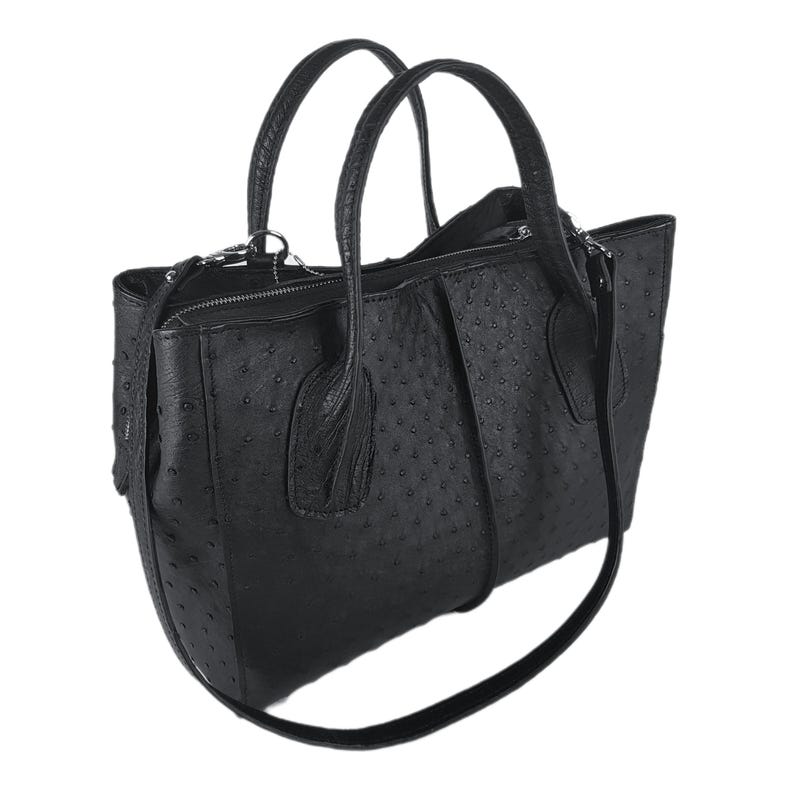 May include: Black leather handbag with a textured ostrich-like pattern. The bag has two top handles and a long shoulder strap.