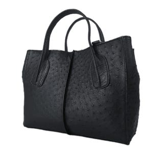 May include: A black ostrich leather tote bag with two top handles.