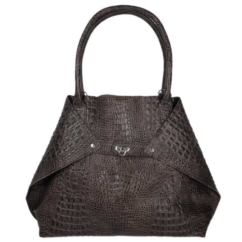 May include: A brown leather tote bag with a crocodile embossed pattern and a silver clasp closure.