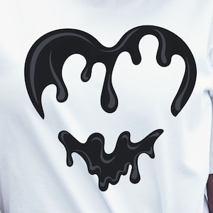 May include: A white t-shirt with a black dripping heart graphic.