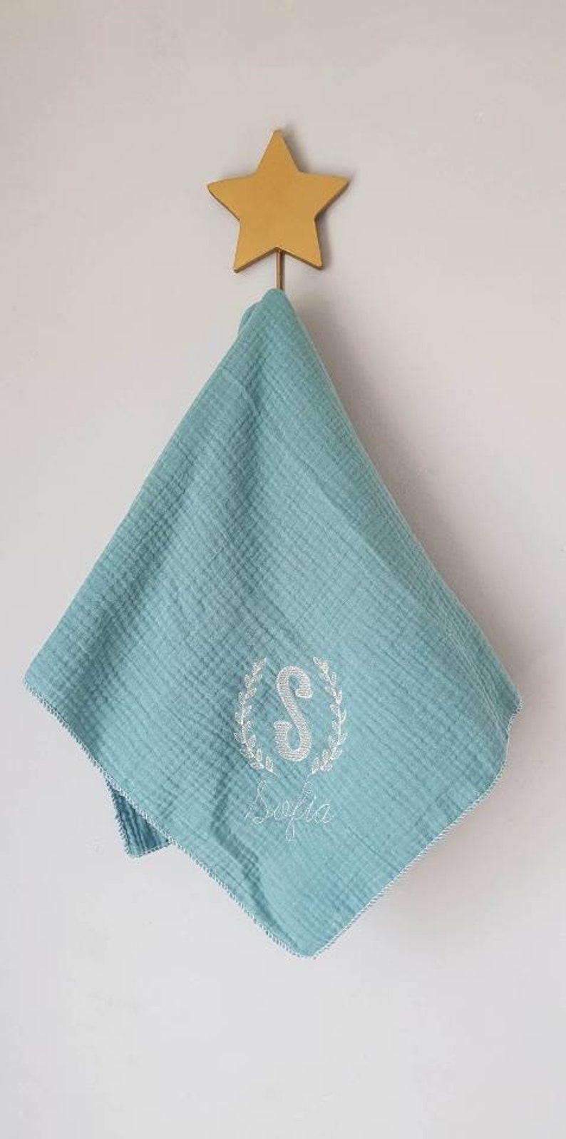 Embroidered and personalized baby swaddle with an initial wreath of leaves and a first name. Several colors to choose from. image 1