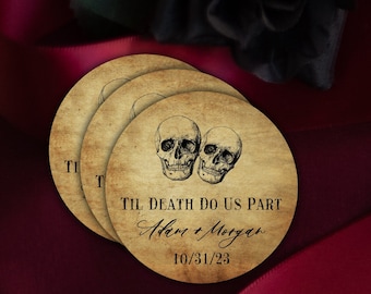 May include: Three round, brown, vintage-style paper coasters with a black and white illustration of two skulls. The text "Til Death Do Us Part" is printed in black cursive font, followed by "Adam & Morgan" in black cursive font and the date "10/31/23" in black font.