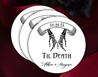 May include: Three white round paper coasters with black skeleton hands holding each other, a banner with the text "10.28.23" and the text "Til Death Adam + Morgan".