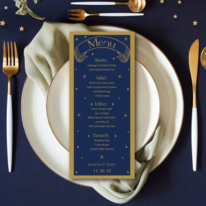 May include: A gold and blue wedding menu card with a star design. The menu includes starter, salad, entree, and dessert options. The text at the bottom reads "Jonathan & Taylor 11.20.22".