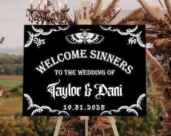 May include: Black wedding sign with white text that reads "Welcome Sinners to the Wedding of Taylor & Dani 10.31.2025". The sign has a skull and butterfly graphic and a cloud design.