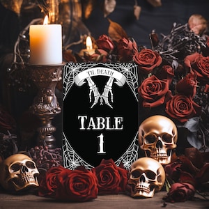 May include: Black table number card with white spiderweb design and skeletal hands. The card reads "Til Death Table 1". The card is surrounded by red roses and skulls.