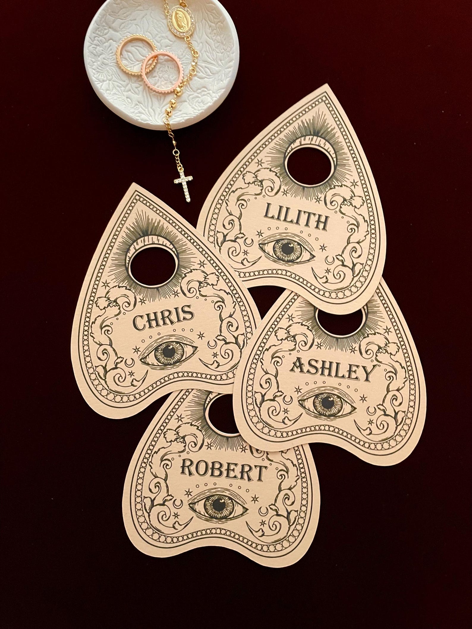 A Planchette-Shaped Wooden Name Card Personalized wooden planchette-shaped place markers with engraved names.