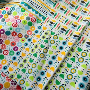 May include: A collection of colorful fabric swatches with different patterns. The patterns include circles, flowers, and fish. The fabrics are all white with bright colors.