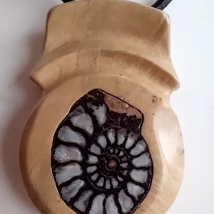 Contemporary necklace carved root box inlaid with an Ammonite (fossil) on leather cord
