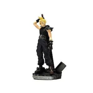 May include: A black and gold figurine of a character from Final Fantasy VII, standing on a base with the words "Final Fantasy VII" printed on it.