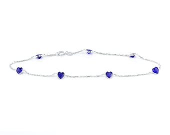 May include: A silver anklet with a delicate chain and blue heart-shaped charms.