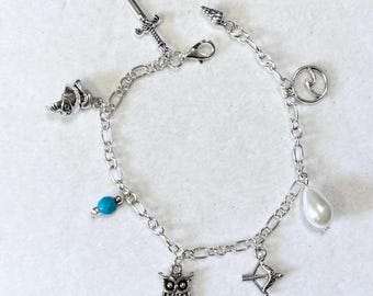 Odyssey inspired charm bracelet with tibetan silver and glass charms Handmade