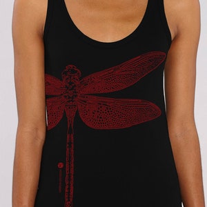 May include: A black tank top featuring a red dragonfly graphic print. The dragonfly is detailed and has a long, thin body with delicate wings.