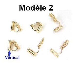 May include: A set of six gold-toned metal clip-on earring findings with a cylindrical attachment point. The text Mod&egrave;le 2 is displayed at the top, and a blue arrow points to one of the components with the label Vertical below it.
