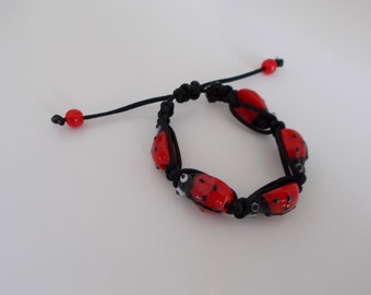 RED and BLACK COCCINELLE children's bracelet in glass, black macramé thread