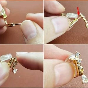 May include: A gold-toned clip-on earring featuring a curved bar set with small clear stones and a single pear-shaped drop stone. The earring includes a clear silicone cushion pad on the clip mechanism for comfort and a red arrow indicating placement.