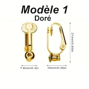 May include: Gold-coloured clip-on earrings labelled Mod&egrave;le 1 Dor&eacute;. The earrings feature a hinged mechanism and a circular base. Dimensions are indicated as 21mm/0.83in in height, 7.6mm/0.3in in width, and 10mm/0.39in in depth for the earring components.