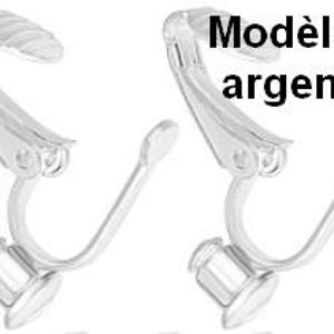 May include: A pair of silver-toned metal clip-on earring findings featuring a hinged mechanism with a textured grip pad at the top and a flat circular base at the bottom for attaching decorative elements. The text Mod&egrave;le 1 argent&eacute; is visible.