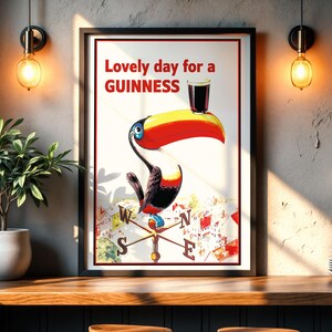 May include: A framed vintage Guinness advertisement featuring a toucan with a pint of Guinness on its beak. The poster reads "Lovely day for a Guinness" in red text. The toucan is colorful, with a yellow beak and red accents.