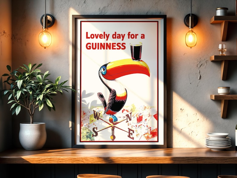 May include: A framed vintage Guinness advertisement featuring a toucan with a pint of Guinness on its beak. The poster reads "Lovely day for a Guinness" in red text. The toucan is colorful, with a yellow beak and red accents.