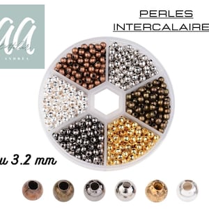 May include: A clear plastic container with six compartments filled with small, round beads in various metallic colors. The text "PERLES INTERCALAIRES" is at the top, and "4 ou 3.2 mm" is at the bottom. Several individual beads are shown below.