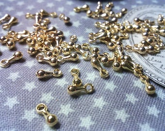 x 100 charms drops in Golden brass.