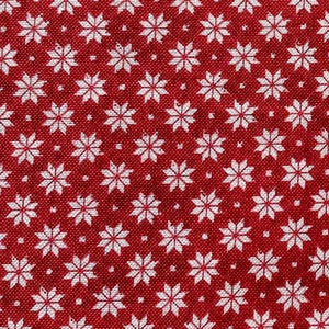May include: Red fabric with a white snowflake pattern. The snowflakes are small and evenly spaced.