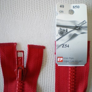 May include: A red zipper with a metal slider and a pull tab. The zipper is 40 cm long and is labeled "Z 54 Eclair Prym Fermeture Eclair".