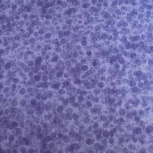 May include: Close-up of a fabric featuring a repeating pattern of overlapping, translucent, purple circles. The circles vary in size and density, creating a textured, abstract design on a light purple background.