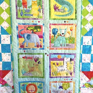 May include: A colourful quilt with a patchwork design featuring various animals in different coloured squares. The animals include a lion, zebra, elephant, dog, crocodile, and cat.
