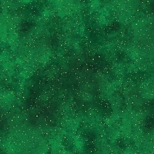 May include: A green background with a scattered pattern of small gold glitter.