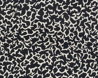 May include: Black and white abstract floral pattern on a white background. The pattern is made up of small, irregular shapes that resemble leaves.