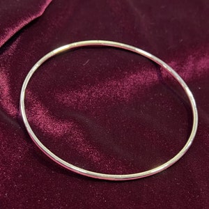 May include: A simple silver bangle bracelet, a classic and timeless piece of jewellery.