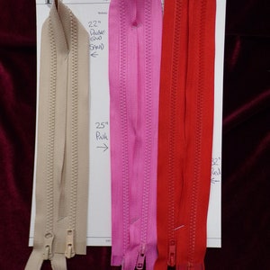 May include: Three zipper closures in different colours: beige, pink, and red. The zippers are 22 inches long and labelled "Double GND SAND", "25" Pinh", and "22" Red".