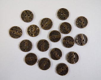 May include: A collection of 15 antique gold-toned metal buttons with a textured surface. Each button has four holes and a decorative design.
