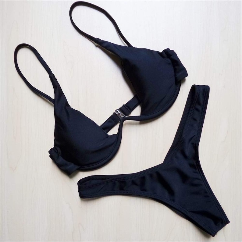 May include: Black bikini with a halter top and a high-cut bottom.