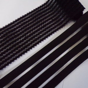 May include: Two black elastic trims. One trim is a black, stretchy, woven lace with a wavy pattern. The other trim is a black, stretchy, flat elastic with three vertical stripes.
