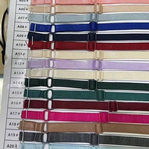 May include: A chart displaying 23 different coloured 1.0 cm wide elastic straps with metal clasps. The straps are labelled A01 to A23.