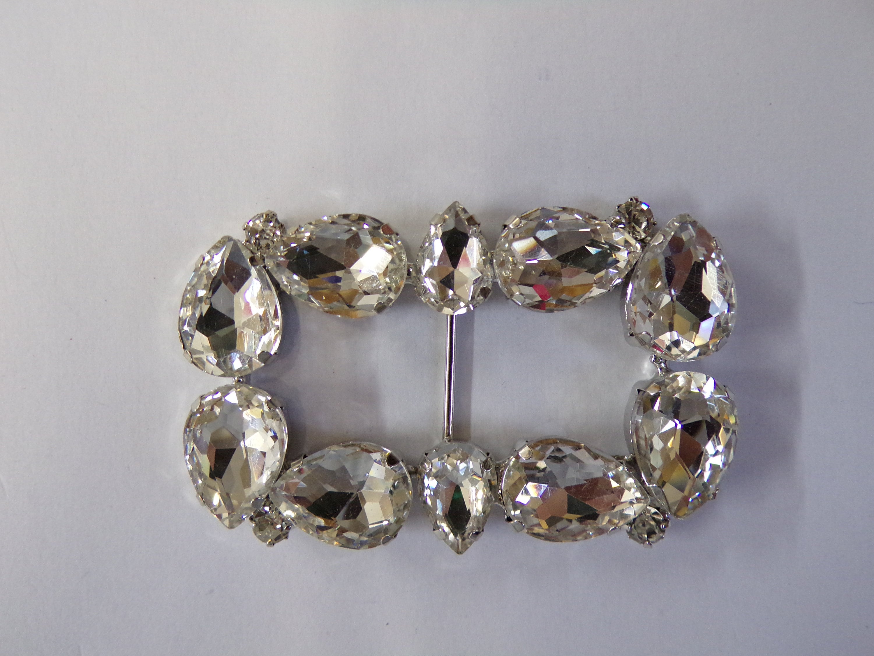 Ornate metal belt buckle with a floral design in the center The buckle