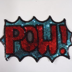 May include: A red and blue sequined patch with the word "POW!" in a comic book style font.
