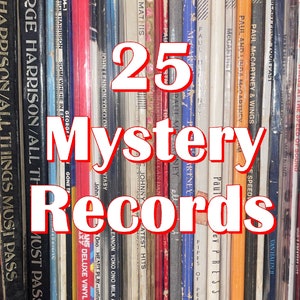 May include: A collection of 25 vintage vinyl records with various artists and album titles. The records are arranged vertically and are mostly in shades of orange, yellow, and brown.