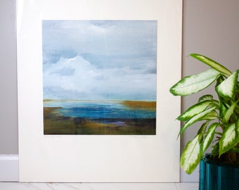 May include: A framed abstract painting of a landscape with a blue body of water, brown land, and a white cloudy sky. The painting is signed "Carol Lee" in the bottom right corner.