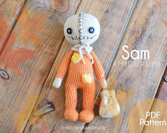 May include: Crocheted amigurumi doll of Sam from the movie 'Trick 'r Treat'. The doll is wearing an orange jumpsuit with yellow stars and a brown sack. The doll has a stitched-on mouth and black button eyes. The text 'Sam Amigurumi' and 'PDF Pattern' is visible in the image.